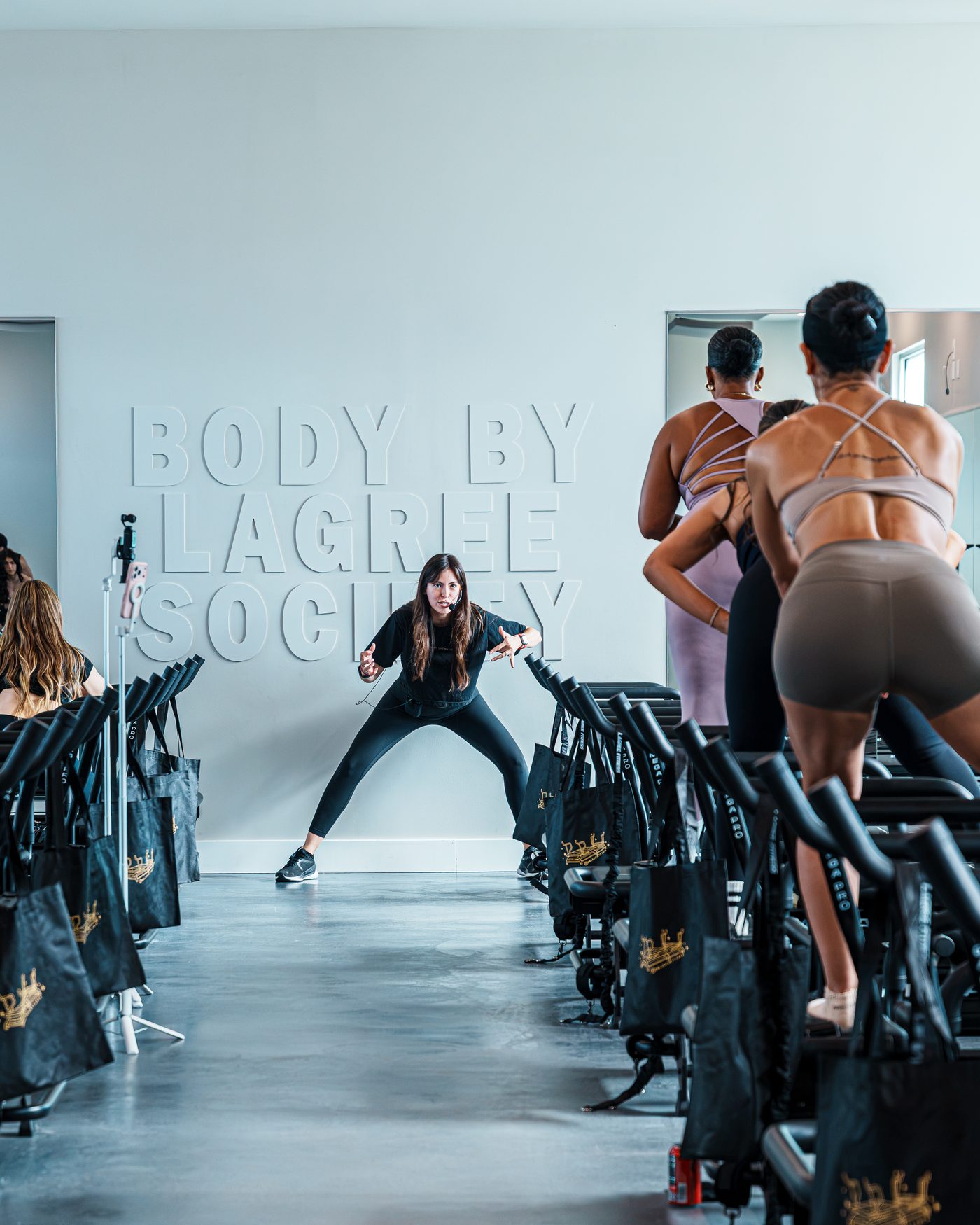 A BBL Society trainer demoing a move under the studio wall letters