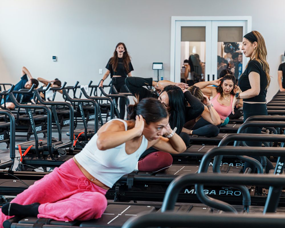 Rows of members in a side plank on their carriages